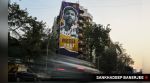 Vehicles drive past a building in Mumbai where graffiti of Lionel Messi has been drawn by artist Mooz Graffiti. (Express Photo/Sankhadeep Banerjee)