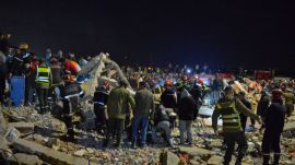Rescue workers and reisdents search for survivors amid the wreckage of two collapsed buildings in Fez, Morocco, Tuesday, Dec. 9, 2025. (AP Photo/Ahmed Alaoui Mrani)
