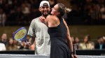 Nick Kyrgios and Aryna Sabalenka interact at the net during their Battle of the Sexes match, in Dubai, United Arab Emirates, Sunday Dec. 28, 2025. (AP Photo)