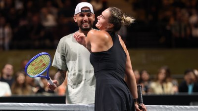Nick Kyrgios and Aryna Sabalenka interact at the net during their Battle of the Sexes match, in Dubai, United Arab Emirates, Sunday Dec. 28, 2025. (AP Photo)