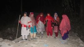 Women guarding Laghat village at night