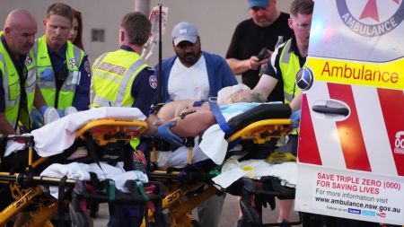 Emergency workers transport a person on a stretcher after a reported shooting at Bondi Beach in Sydney. (AP Photo)