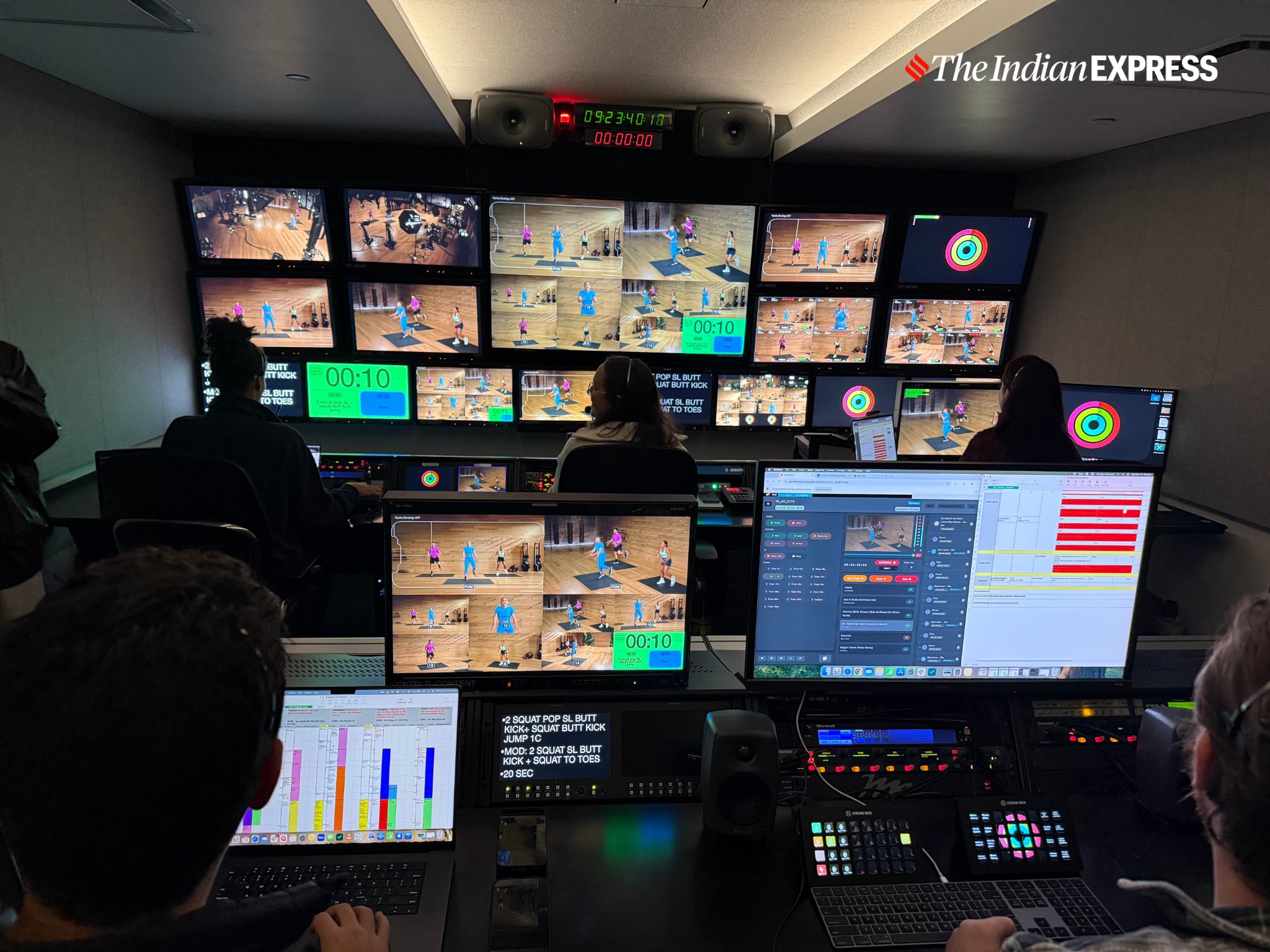The production team fine-tunes lighting, graphics, and angles during a Fitness+ workout shoot. The control room was the only accessible spot in the sprawling Apple Fitness+ studio. (Image: Bijin Jose/The Indian Express)