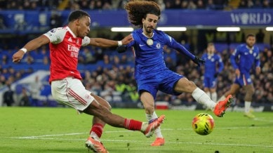 Arsenal's Jurrien Timber, left, kicks the ball ahead of Chelsea's Marc Cucurella during the English Premier League soccer match between Chelsea and Arsenal in London, England, Sunday, Nov. 30, 2025. (AP Photo)