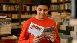 boy-reading-comics-library Contemporary books are filled with characters who rarely appeared earlier—queer protagonists, children from different regions. (Freepik)