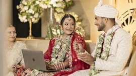 bride working on laptop at her wedding