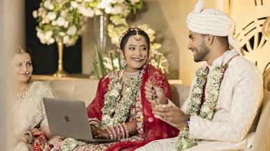 bride working on laptop at her wedding