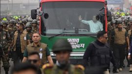 BNP) Acting Chairman Tarique Rahman waves to supporters from a bus in Dhaka after returning from London