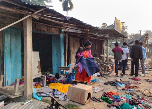 People at a vandalised area following violent protests at Kheroni, in Karbi Anglong district, Assam, Wednesday, Dec. 24, 2025.
