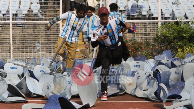 People barge into the ground after breaking chairs and the gates tjhat separated the stands from the field. (Express Photo by Partha Paul)