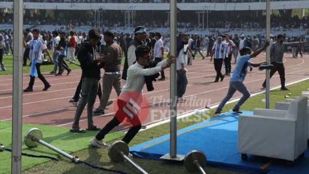 Spectators attempt to bring down the tent erected near the ground, shortly after Messi exited the stadium from the shade. (Express Photo by Partha Paul)