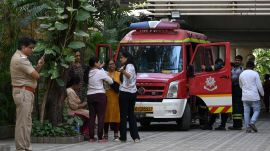 Residents wait outside for a fire on the 14th floor of a residential building to be put out at Andheri West.