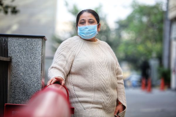 Pooja Khurana, at her work place in Nehru Place, who is struggling with breathing problems due to pollution, at New Delhi on Thursday, December 12, 2025. Express photo by Abhinav Saha