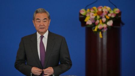 China's Foreign Minister Wang Yi looks as he arrives to deliver an opening speech for the annual symposium on the international situation and China's foreign relations held by China Institute of International Studies at the Diaoyutai State Guesthouse, in Beijing, Tuesday, Dec. 30, 2025. (AP Photo)