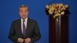 China's Foreign Minister Wang Yi looks as he arrives to deliver an opening speech for the annual symposium on the international situation and China's foreign relations held by China Institute of International Studies at the Diaoyutai State Guesthouse, in Beijing, Tuesday, Dec. 30, 2025. (AP Photo)