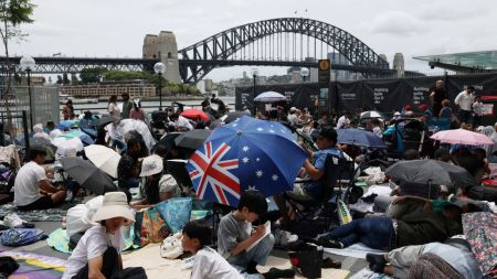 People gather at Circular Quay near the Sydney Opera House ahead of New Years Eve fireworks, in Sydney, Australia, December 31, 2025.