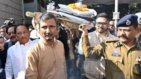 Raipur, Dec 24 (ANI): Chhattisgarh Chief Minister Vishnu Deo Sai and others carry the mortal remains of Jnanpith Award recipient and eminent Hindi writer Vinod Kumar Shukla during his funeral procession with full state honours, in Raipur on Wednesday. (@vishnudsai X/ANI Photo)
