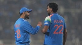 India's Virat Kohli , left, chats with India's Harshit Rana during the first One Day International match between India and South Africa in Ranchi, India, Sunday, Nov. 30, 2025. (AP Photo)
