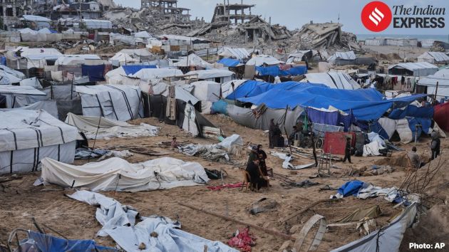 Rubble lay at the site of the destroyed home in central Gaza as residents and neighbours sifted through debris to locate belongings