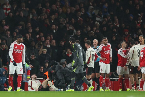 Trainers check on Liverpool's Conor Bradley after he was injured and an ensuing altercation with Arsenal's Gabriel Martinelli, during the Premier League match between on Thursday. (AP Photo)