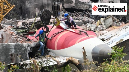 A crane takes down the tail end of crashed Air India Boeing 787-8 Dreamliner in order to dislodge it from a building in Ahmedabad on June 14, 2025.