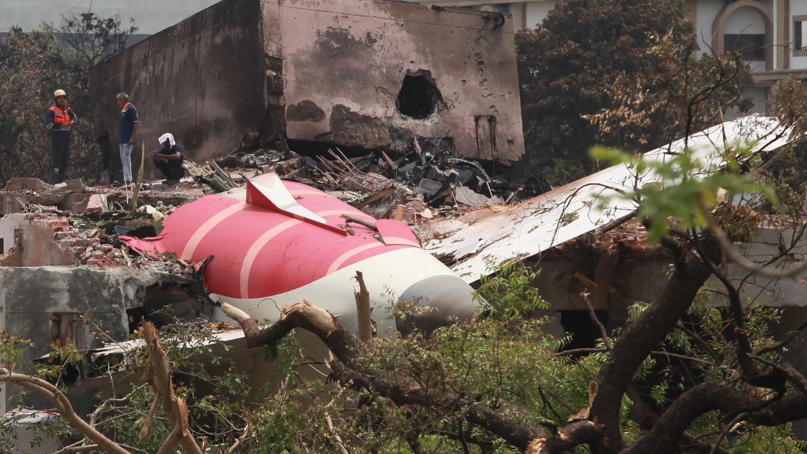 The tail end of the AI 171 stuck on top of the hostel building of BJMC. Express Photo by Bhupendra Rana 13.06.2025