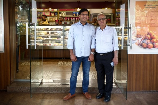 Mahendra Goyal, 73, the third-generation custodian of Brijwasi, with his son Anuj, 40, outside the Brijwasi Sweets Worli store. (Express photos by Akash Patil)