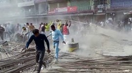 Locals from Beldanga block road hold a protest against the migrant laborers lynched case in Bihar