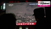 People gather near a large screen at a shopping mall showing CCTV broadcasting a U.S. attack on Venezuela in Beijing, Jan. 4.