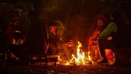 People huddle around a bonfire to beat the cold in Delhi (PTI).