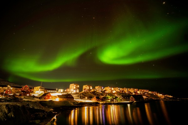 The appearance of northern lights over homes in Nuuk, Greenland.