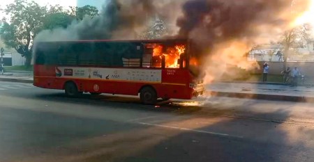 AMTS bus catches fire near Vivanta hotel in Ahmedabad’s Sola area; passengers and staff escape safely.