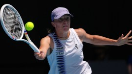 Iga Swiatek of Poland plays a forehand return to Elena Rybakina of Kazakhstan during their quarterfinal match at the Australian Open tennis championship in Melbourne, Australia, Wednesday, Jan. 28, 2026. (AP Photo)