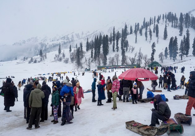 Tourists visit the snow-laden Kongdori on New Year’s Eve in Gulmarg, Baramulla district, one of the coldest places in the region with temperatures dropping well below freezing. (PTI Photo)