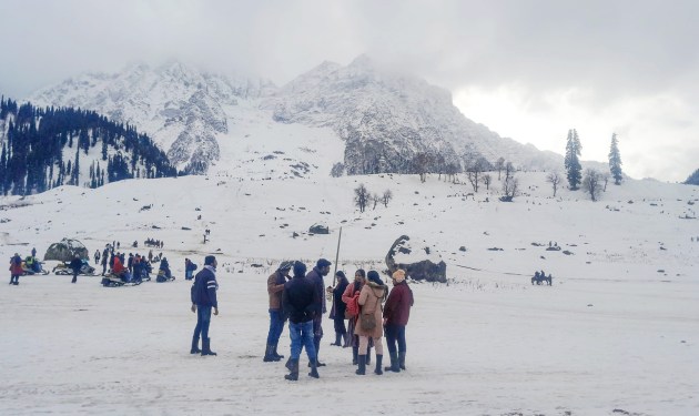 Tourists enjoy a fresh spell of snowfall in Sonamarg on Monday, one of the key tourist destinations that received overnight snow earlier this week. (ANI Photo)