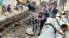 Indore water crisis: School students make their way through the debris amid the pipeline and drainage work undertaken after of deaths caused by consumption of contaminated water in the Bhagirathpura area of Indore, Madhya Pradesh (Photo: PTI)