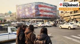 A billboard showing a US aircraft carrier with damaged jets on its deck, and sign reading: "If you sow the wind, you'll reap whirlwind," at the Enqelab-e-Eslami square, in Tehran, Iran, Jan. 25, 2026.