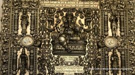 The bride and groom's names are engraved at the centre, surrounded by elephants scattering flowers