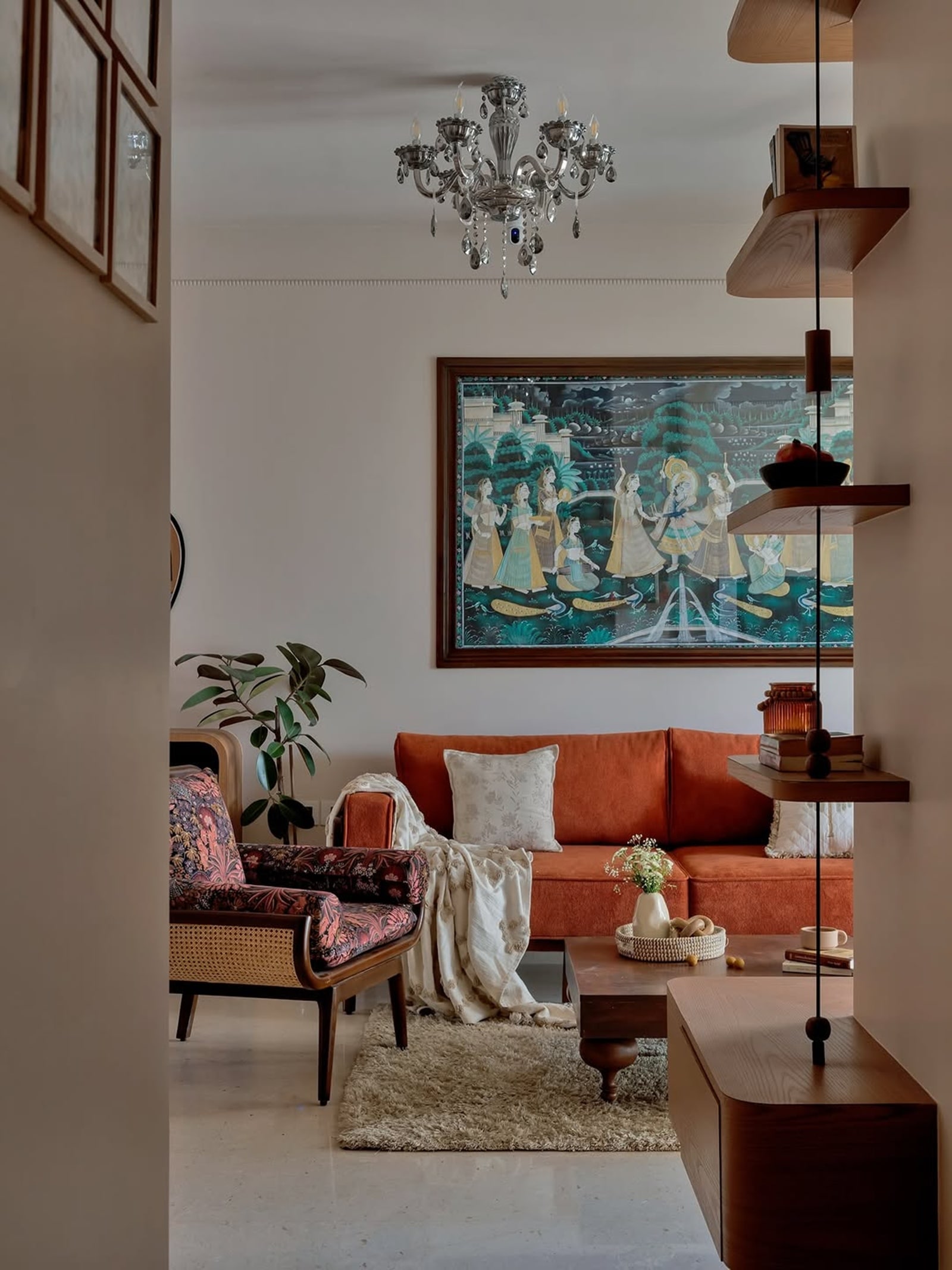 A burnt-orange sofa draws attention, lending warmth and depth to the living room.