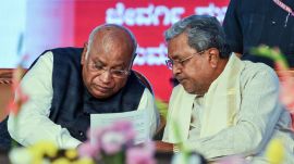 Karnataka Chief Minister Siddaramaiah in a conversation with Congress President Mallikarjun Kharge during an event. Recently Kharge rebuked Congress Govt over teacher shortages at Karnataka schools.