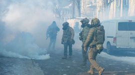 Immigration and Customs Enforcement agents walk through a cloud of their own tear gas at the scene where federal agents fatally shot Alex Pretti in Minneapolis, Minn. (AP)