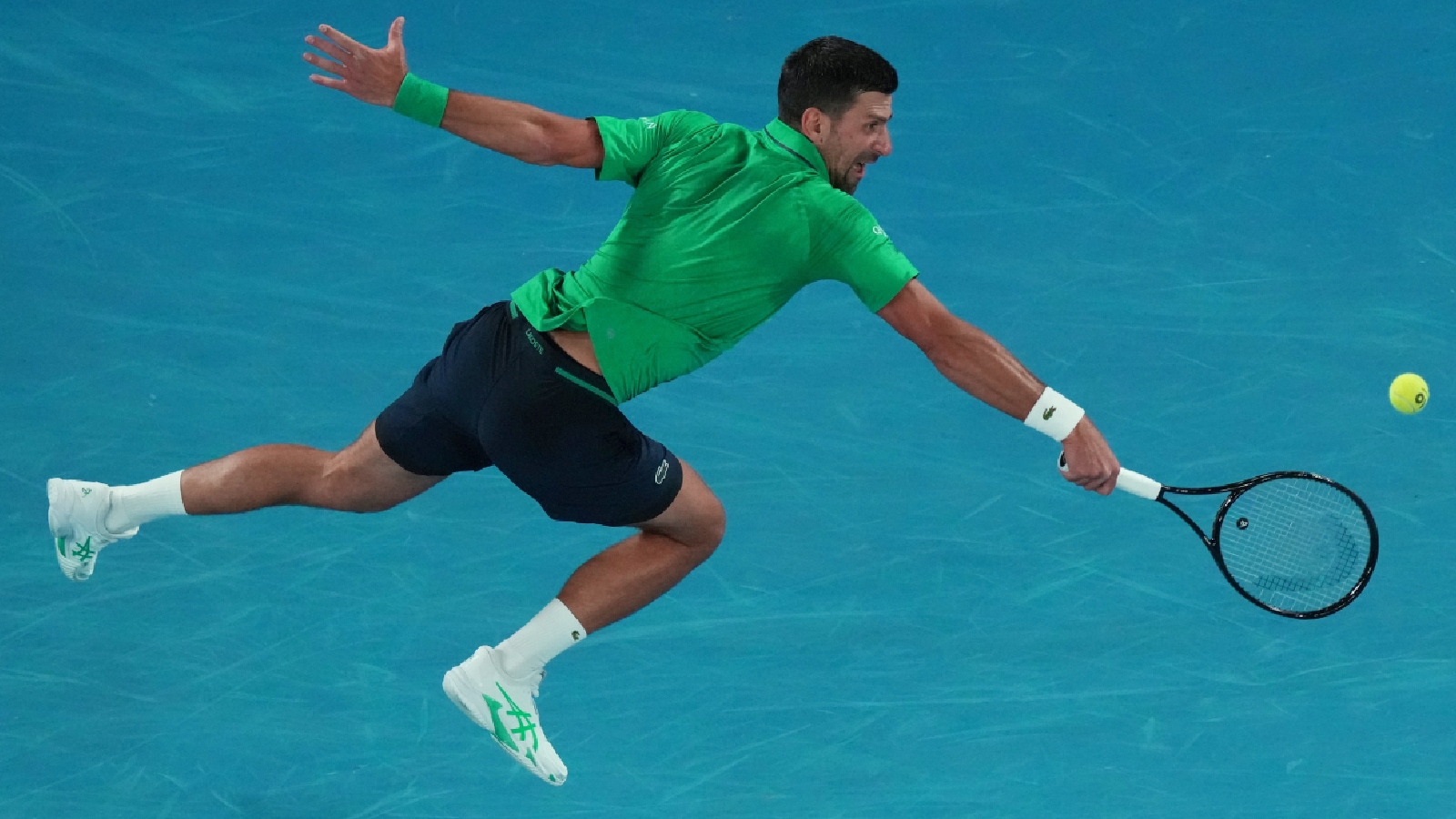 Novak Djokovic of Serbia plays a backhand return to Pedro Martinez of Spain during their first round match at the Australian Open tennis championship in Melbourne. (AP Photo)