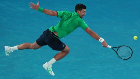 Novak Djokovic of Serbia plays a backhand return to Pedro Martinez of Spain during their first round match at the Australian Open tennis championship in Melbourne. (AP Photo)