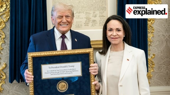Venezuelan opposition leader María Corina Machado presents her Nobel Peace Prize to US President Donald Trump during a meeting at the Oval Office, in Washington, DC.