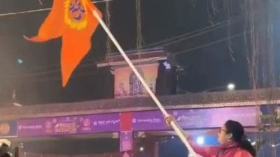 Udupi DC Swaroopa waving a saffron flag