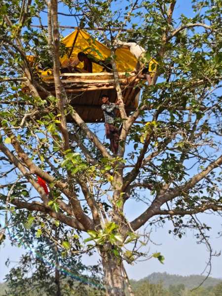 Residents sit on a machan in Sowan village in Jharkhand’s West Singhbhum. (Express photo: Shubham Tigga) 