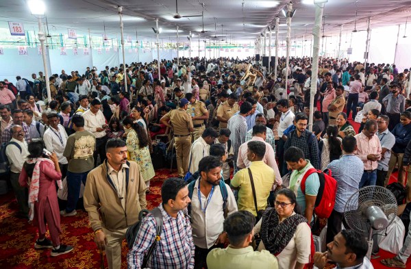 Polling officials gather to collect EVMs and other election material at a distribution centre, a day before Brihanmumbai Municipal Corporation (BMC) elections, in Mumbai, Wednesday, Jan. 14, 2026. (PTI Photo)