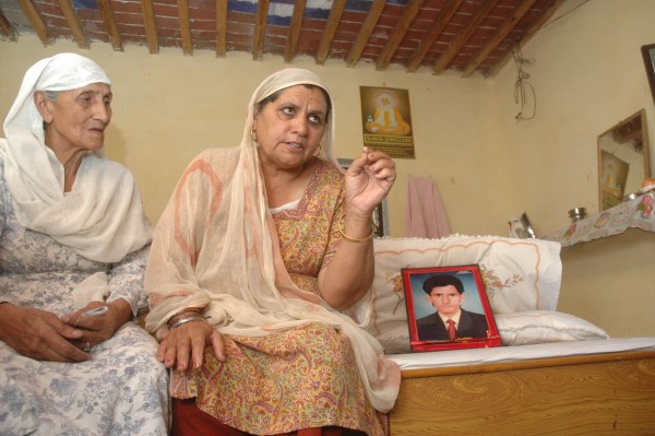 Narinder Kaur mother of Gurinder Singh Purewal refuses to believe that his son had drown in the infamous 'malta boat tragedy'. also seen in the photograph is her brother-in-law. her maternal aunt (left) visited her on thursday.-(Express photograph by Swadesh Talwar)