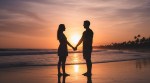 A couple, who are dating, holding hands at the beach