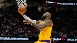 Los Angeles Lakers forward LeBron James goes to the basket in the second half of an NBA basketball game against the Cleveland Cavaliers in Cleveland. (AP Photo)
